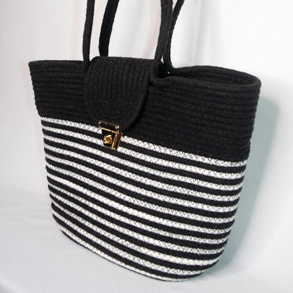 Eco-friendly handwoven tote in black and white cotton with metal clasp